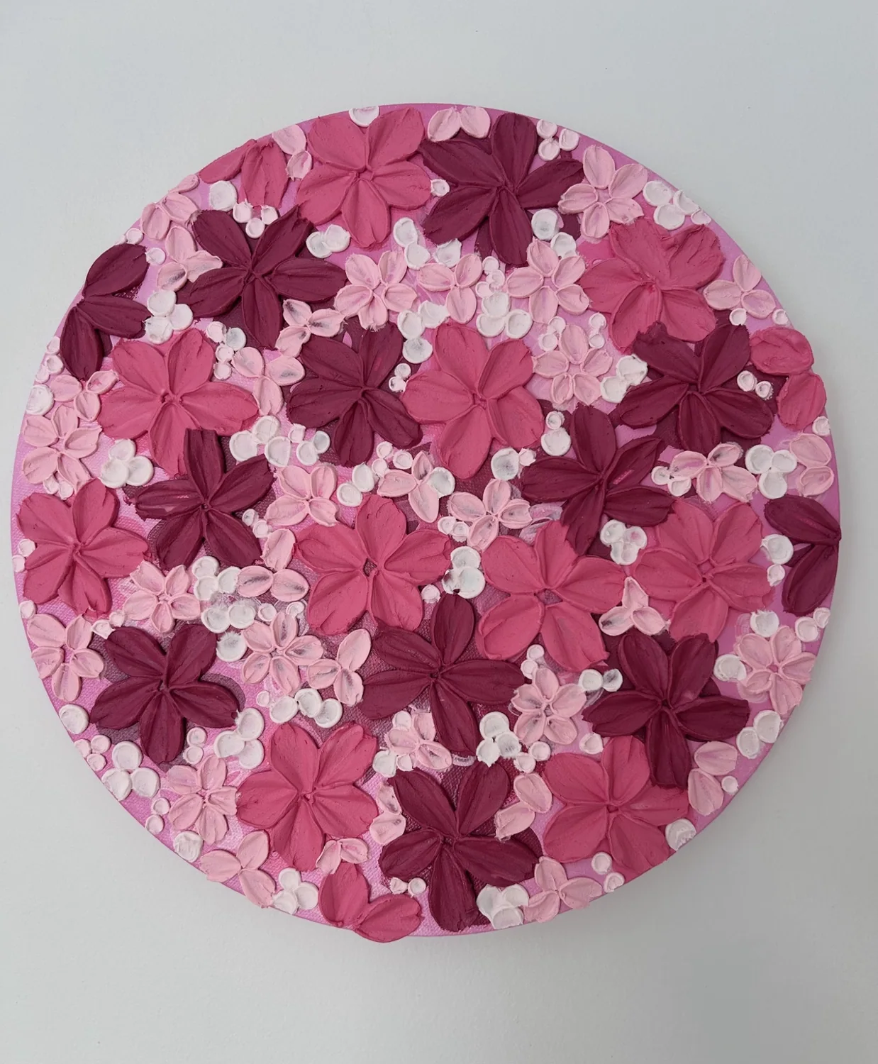 Round pink floral textured artwork