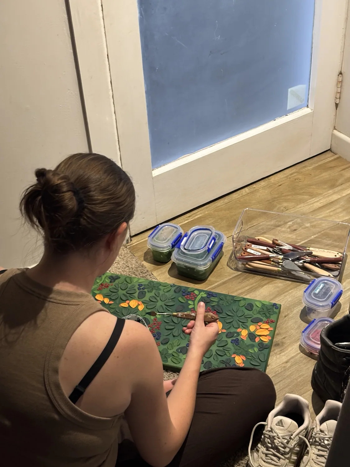 Artist at work creating textured floral painting